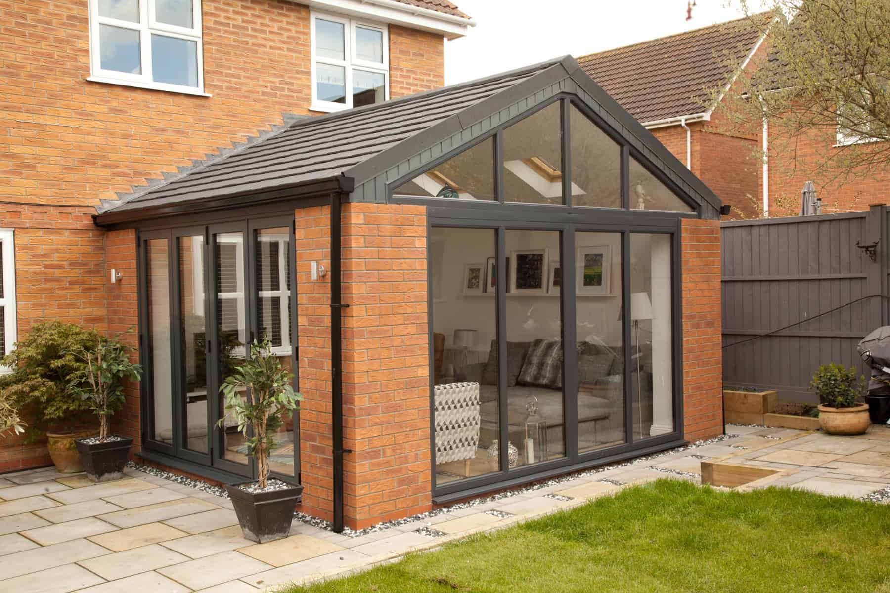 Glass conservatory with a solid tiled roof
